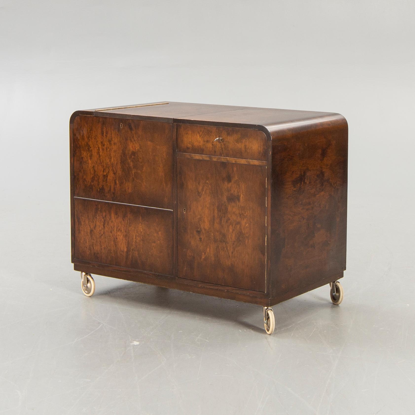 A stained birch bar cabinet from NK dated 1936.