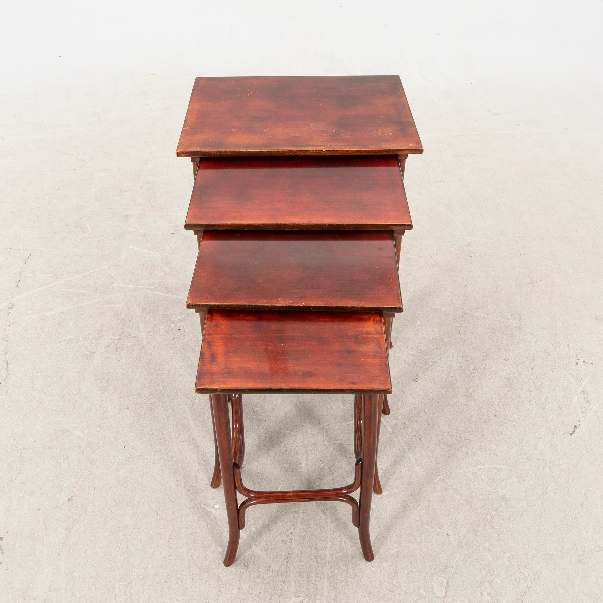 An early 19th century nest of four tables in stained beech from Thonet.