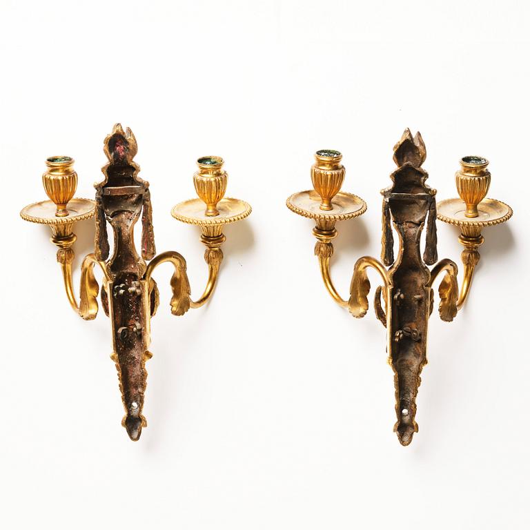 A pair of Louis XVI late 18th century gilded bronze two-light wall-lights.