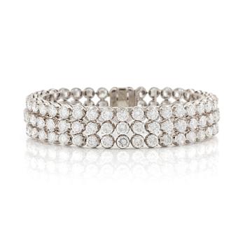 A platinum bracelet set with round brilliant-cut diamonds.