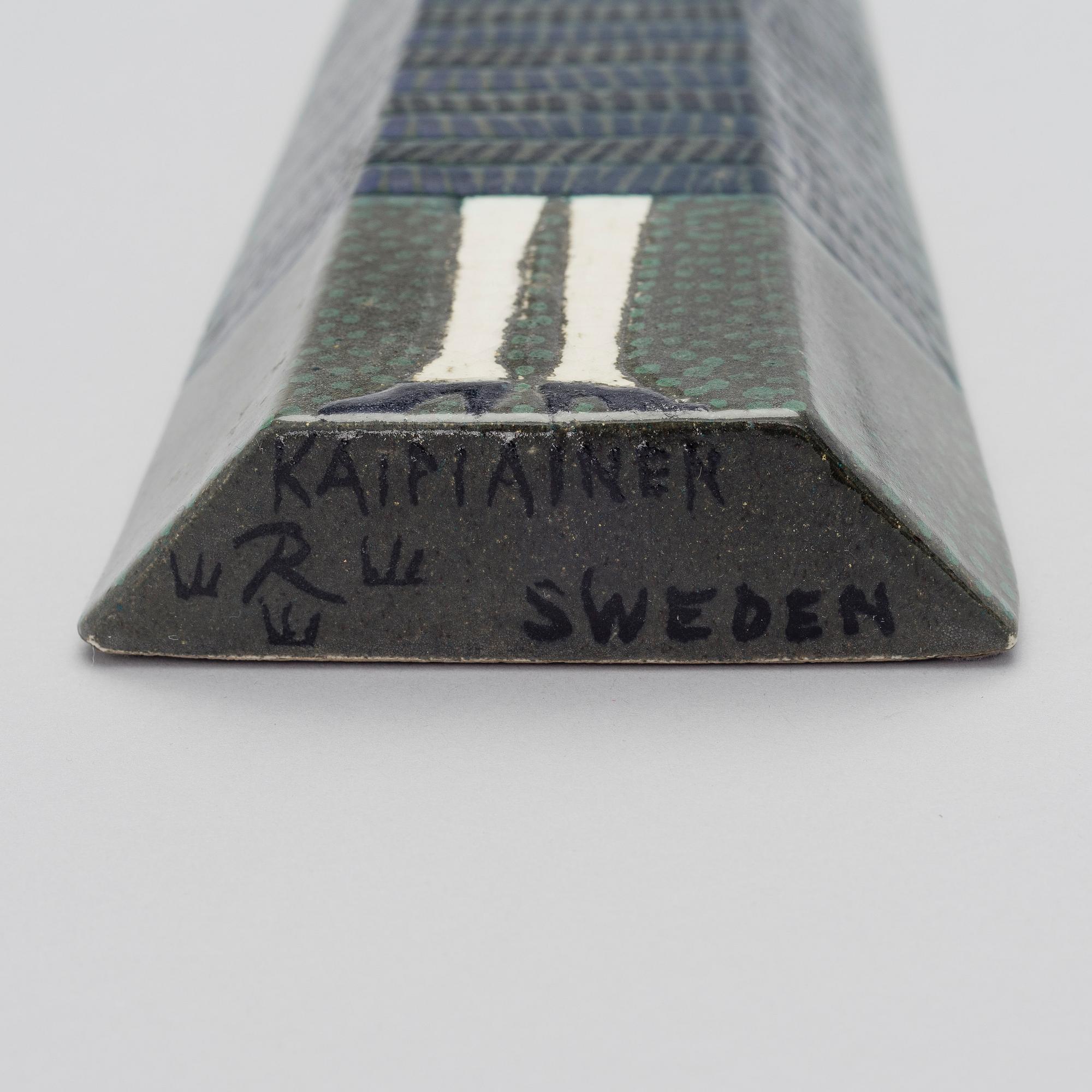 BIRGER KAIPIAINEN, A CERAMIC WALL RELIEF. Big doll. Signed Kaipiainen R Sweden.