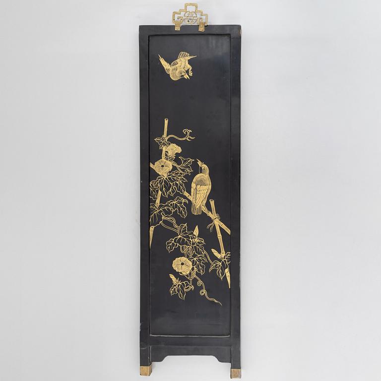 Four black-lacquered wall decorations, China, around 1900.
