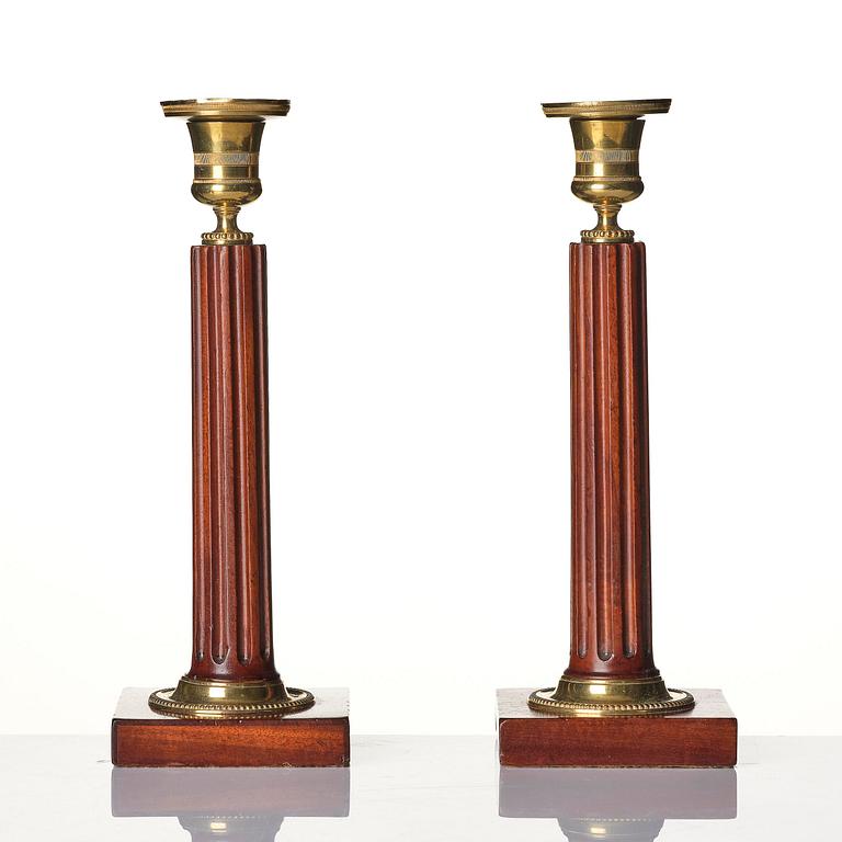 A pair of late Gustavian mahogany and gilt-brass candlesticks, late 18th century.