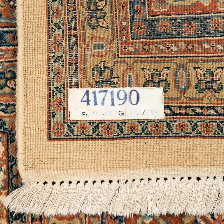 An oriental carpet. Circa 345x245 cm.