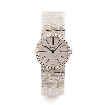 493. A Piaget 18K white gold wrist watch set with round brilliant-cut diamonds.