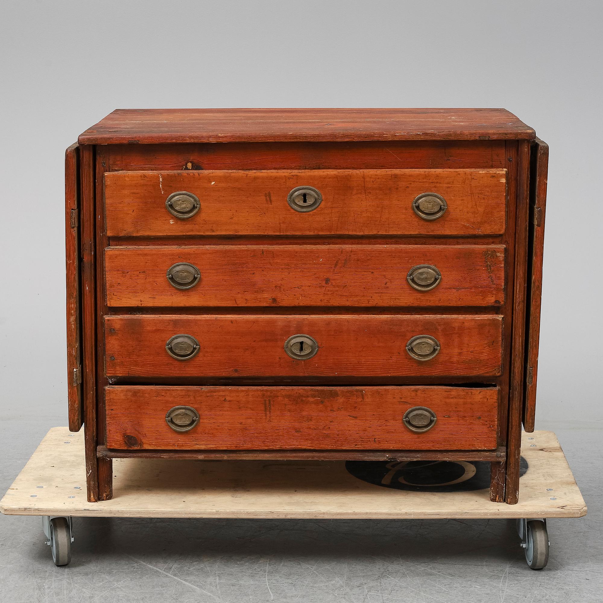 A 19th Century chest of drawers with a table top.