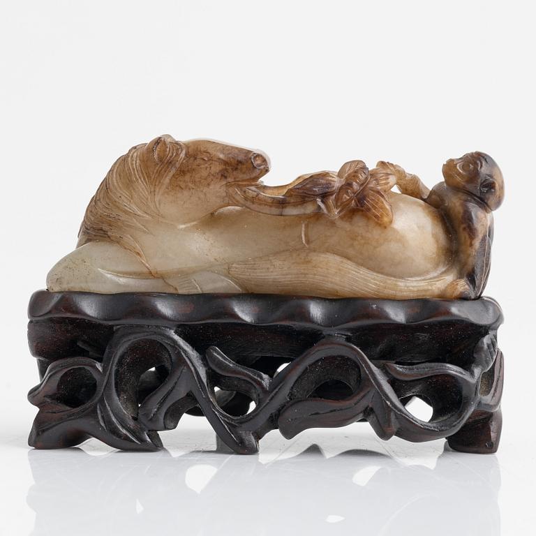 A Chinese sculptured figure of a reclining horse, 20th Century.