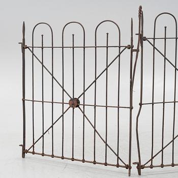 A pair of iron garden gates and a single gate from the early 20th century.