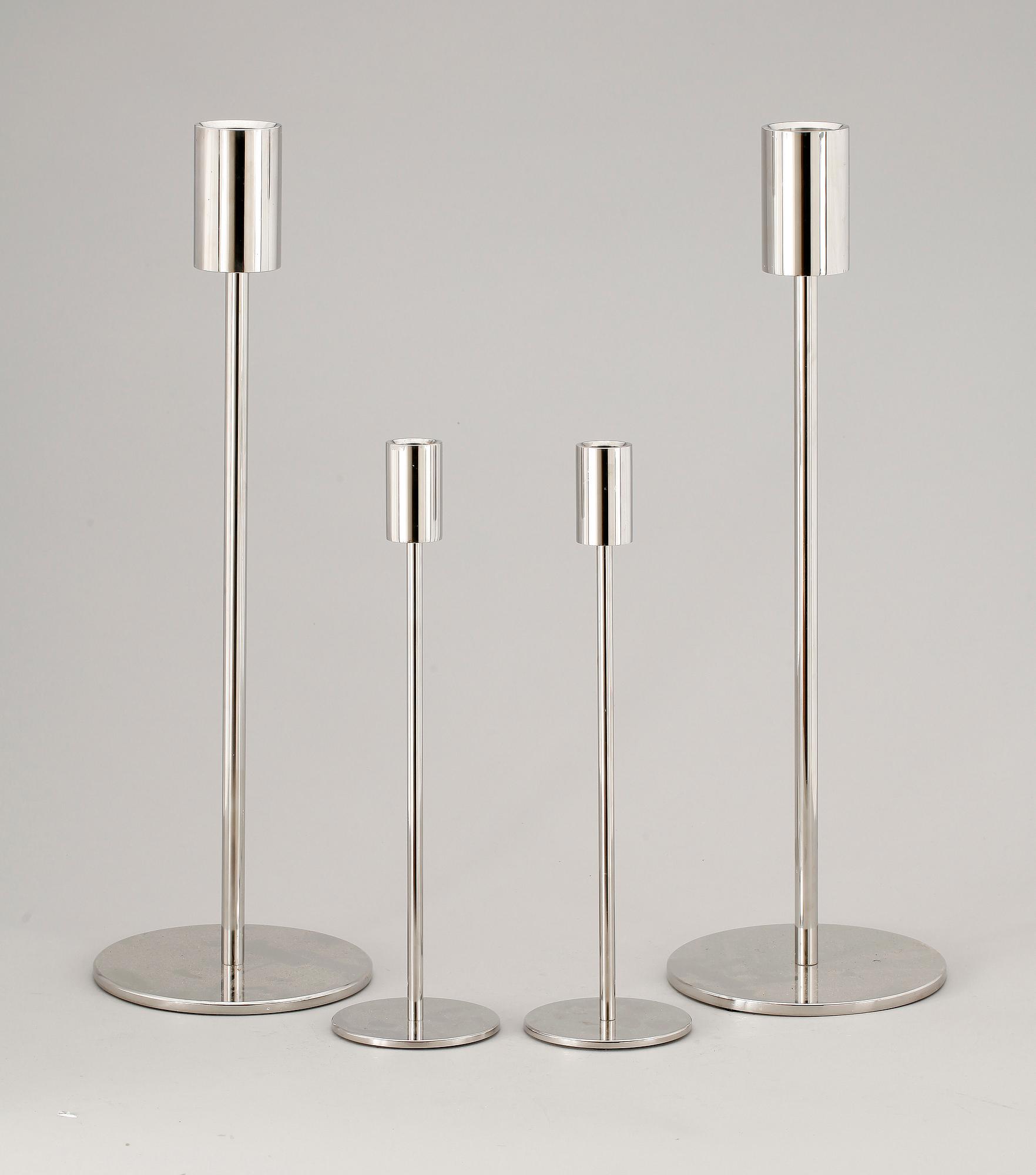 A set of four stainless steel candle sticks 'Noster', by Jonas Lindvall Skandiform.