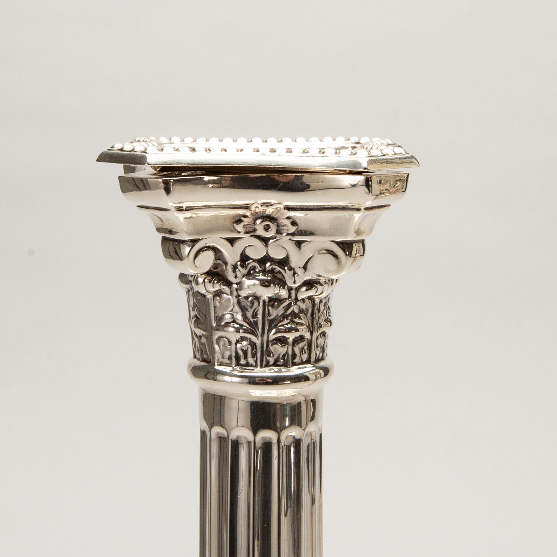 A pair of classical column sterling silver candlesticks Birmingham, 1934, by 'B.G. & Co'.