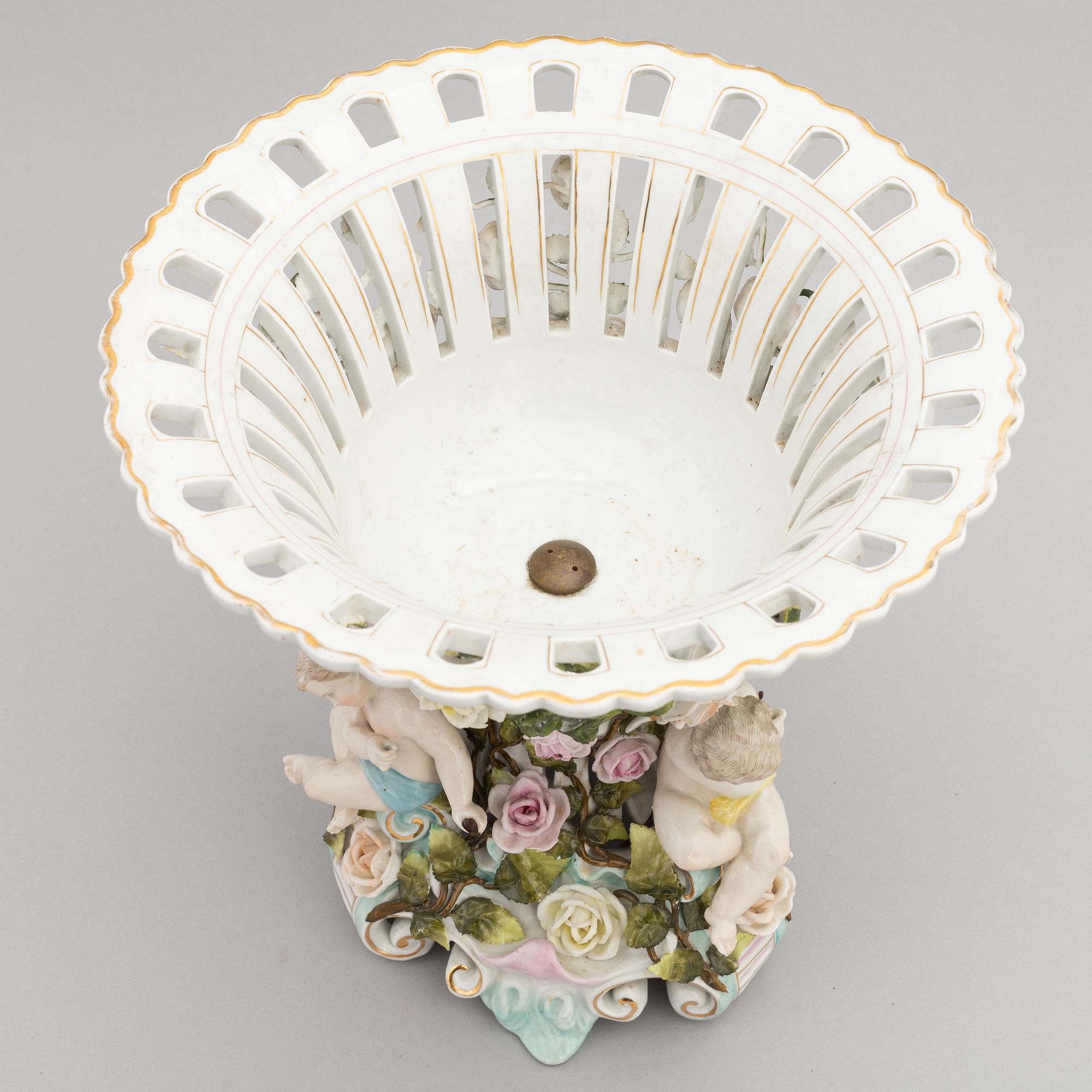 A pair of porcelain rococo style candelabra and a centerpiece bowl, Plaue, Germany, first half of the 20th century.