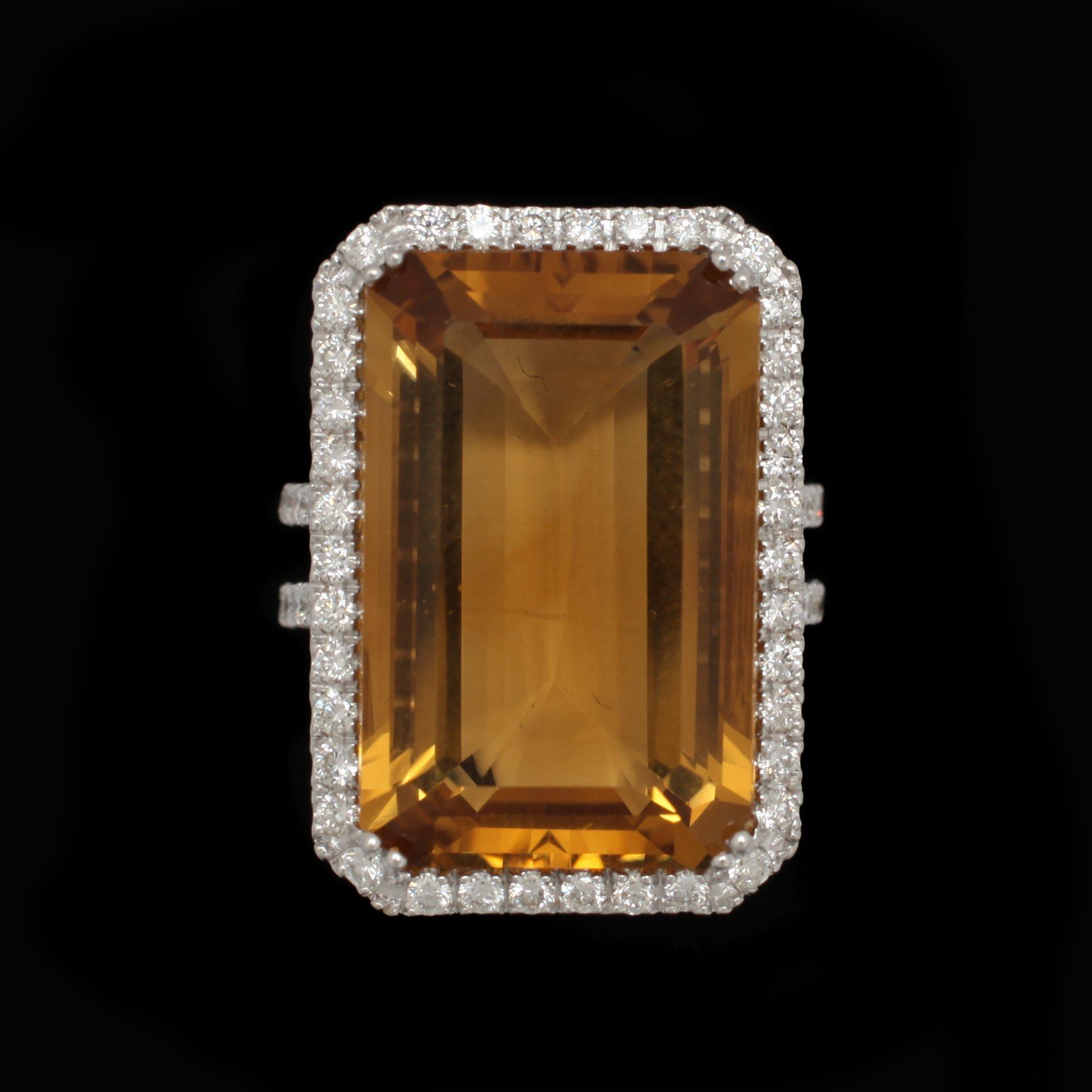 A step cut citrin ring, 25 cts, set with brilliant cut diamonds, tot 0.92 ct.