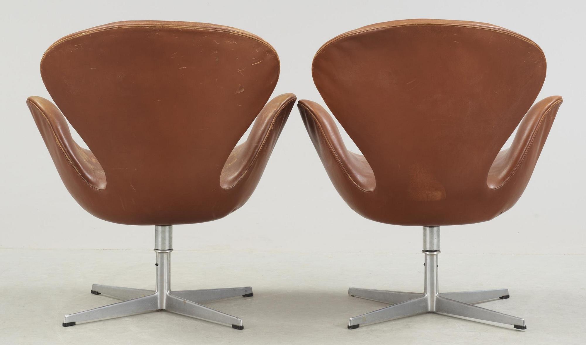 A pair of Arne Jacobsen brown leather 'Swan' chairs, Fritz Hansen, Denmark 1972.