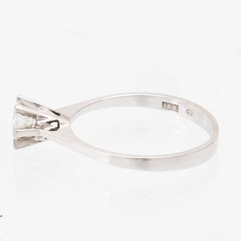 An 18K white gold solitaire ring set with a round brilliant-cut diamond.