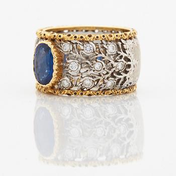 A Buccellati ring in 18K gold and white gold set with a faceted sapphire and round brilliant-cut diamonds.