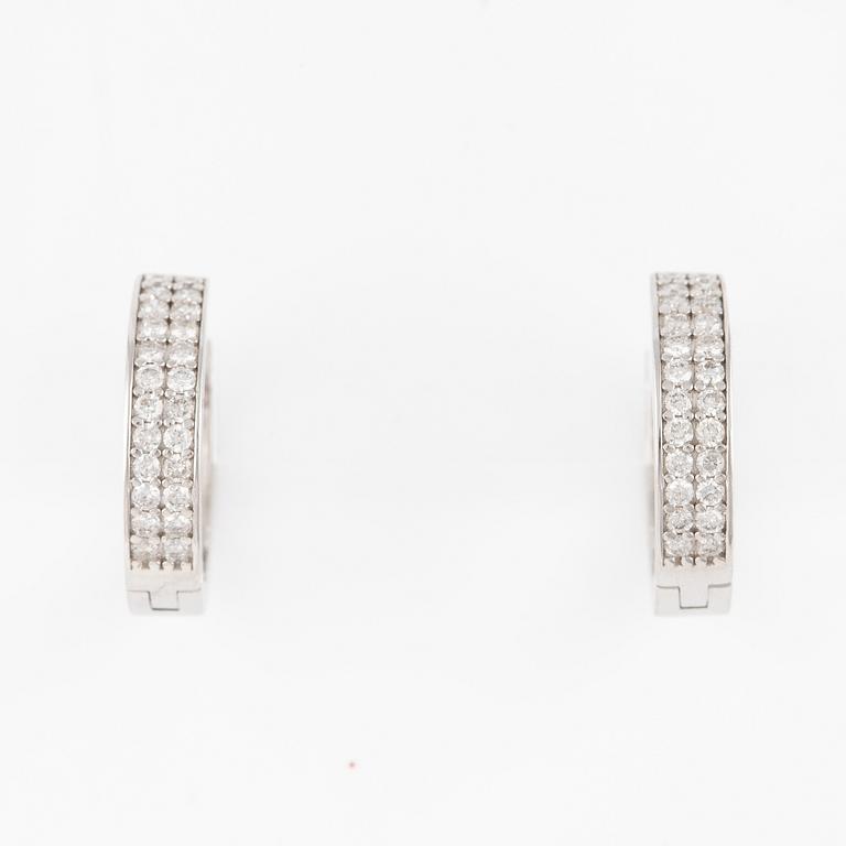 A pair of earrings in 14K gold with round brilliant-cut diamonds.