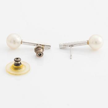 A pair of 18K gold earrings with cultured pearls and round brilliant-cut diamonds.