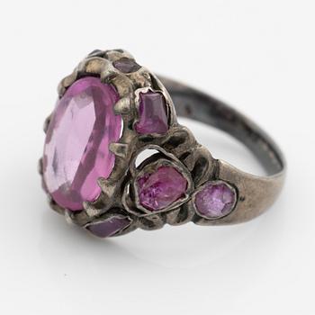 Silver ring with pink stones.