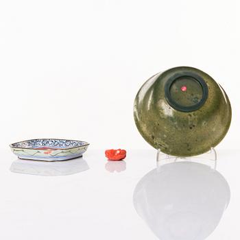 A Chinese enamel on copper coaster, a green stone bowl and a small stone figure, China, Qing dynasty and 20th century.
