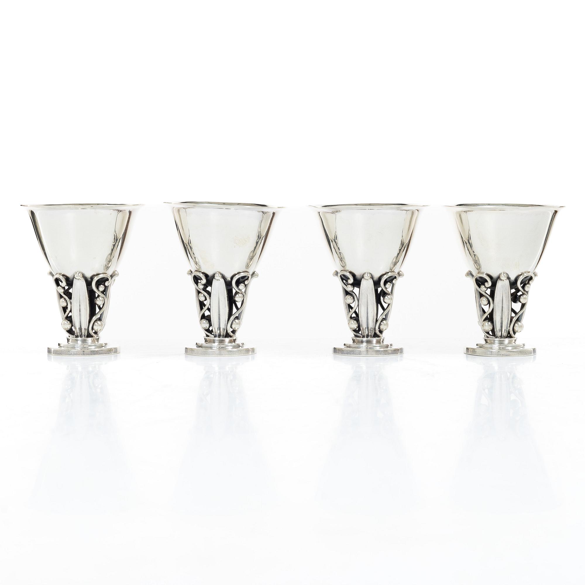 Evald Nielsen, four sterling silver beakers/cups on a foot, Denmark 20th century.
