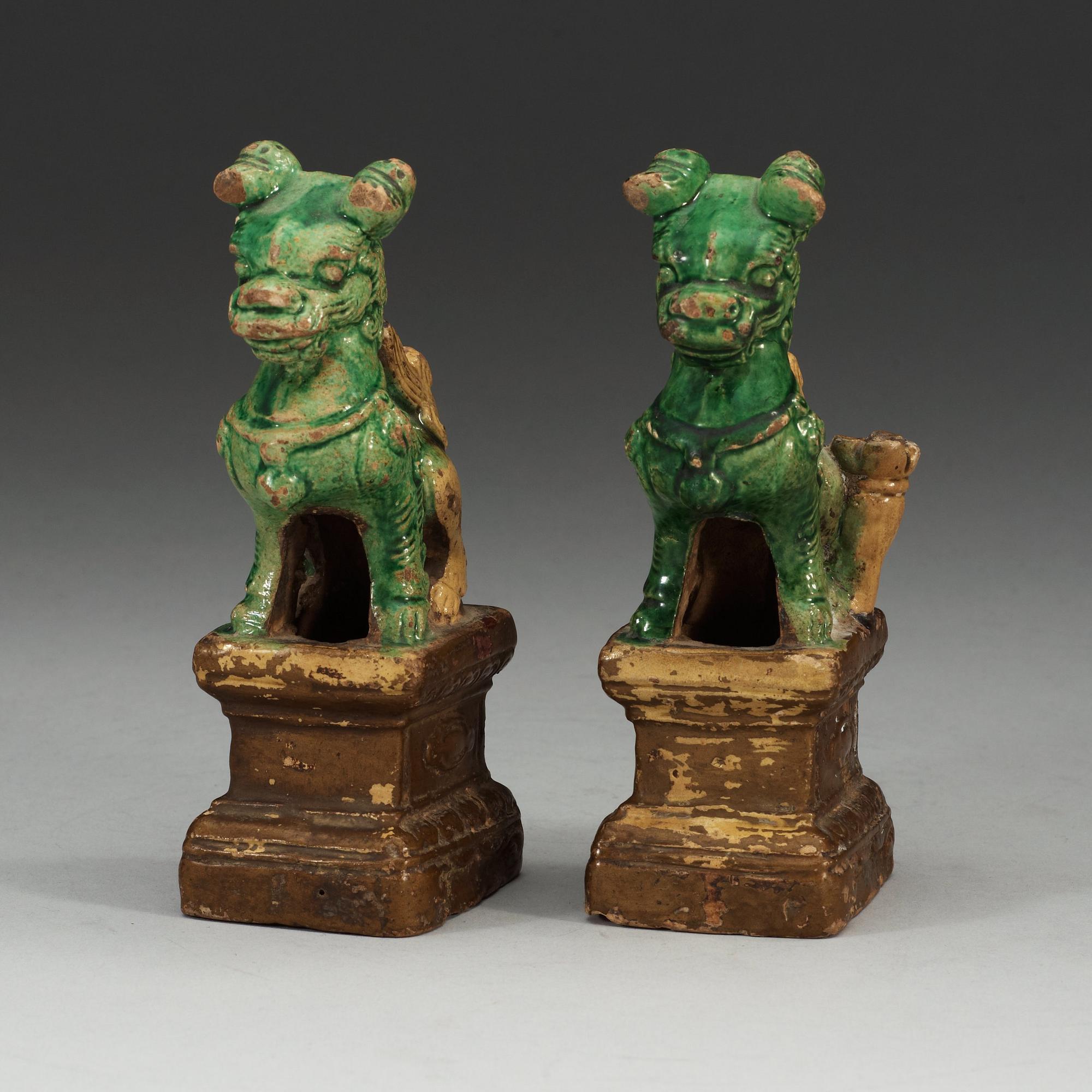 A pair of brown, green and yellow glazed joss stick holders, Qing dynasty (1644-1912).