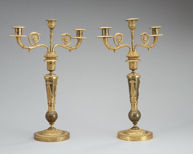 A pair of French Empire early 19th century three-light candelabra.