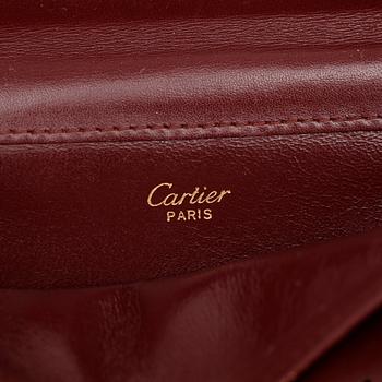 CARTIER, a red leather clutch bag.