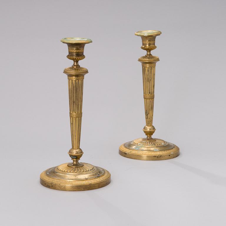 A PAIR OF FRENCH ORMOLU CANDLESTICKS, early 19th century.