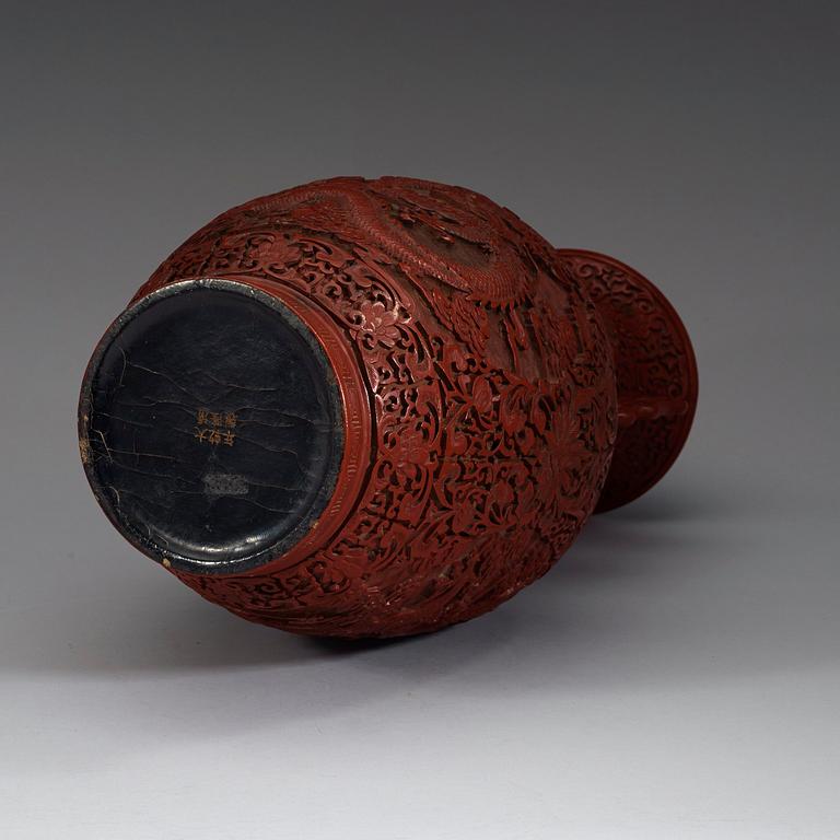 A lacquer vase, late Qing Dynasty (1644-1912) with Qianlong mark.