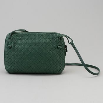 A green Bottega Veneta cross-body  handbag.