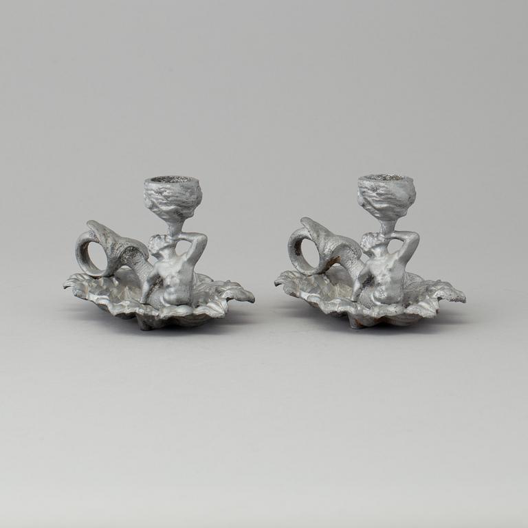 A pair of cast iron candlesticks, marked Verlag bei, A. Meves, Berlin, late 20th century.
