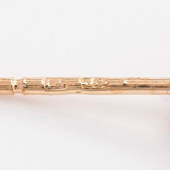 A pair of 14K gold earrings and brilliant cut diamonds.