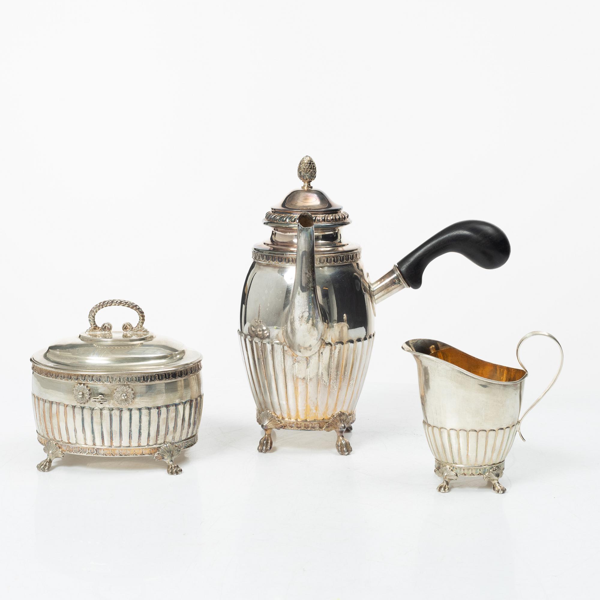 A Swedish silver coffee pot, cream jug and sugar box, Gustavian style, mark of AG Dufva, Stockholm 1911-1912.