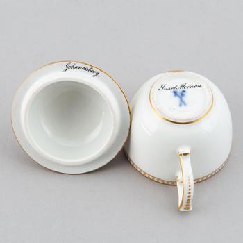A 19th century Meissen miniature lidded porcelain cup decorated with views of Mainau.