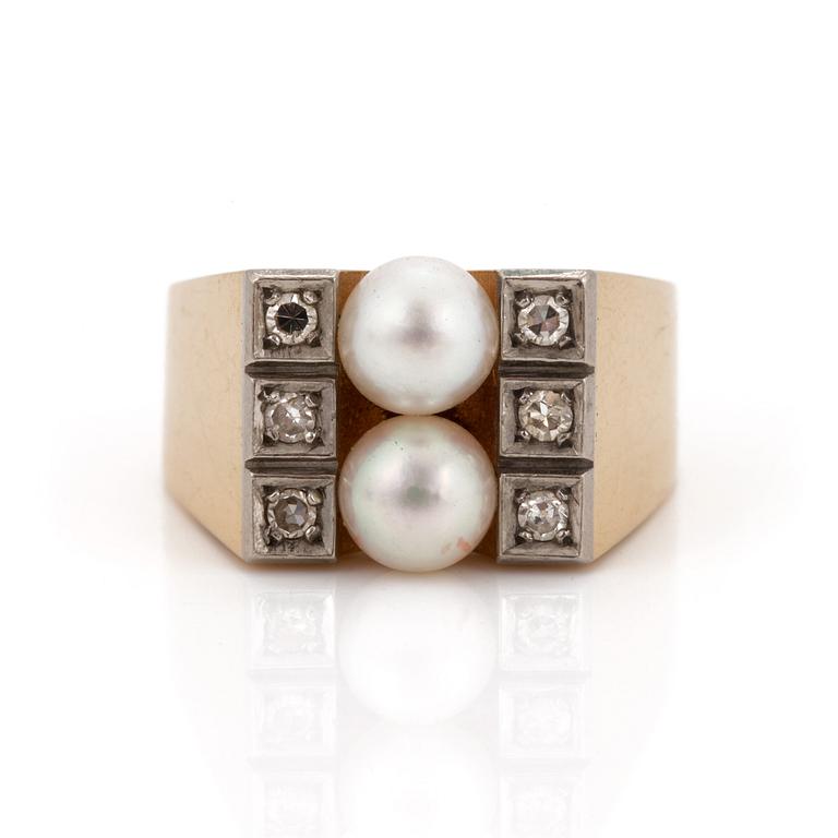 A ring set with two cultured pearls and eight-cut diamonds.