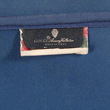 GUCCI, a blue monogram canvas suitcase.