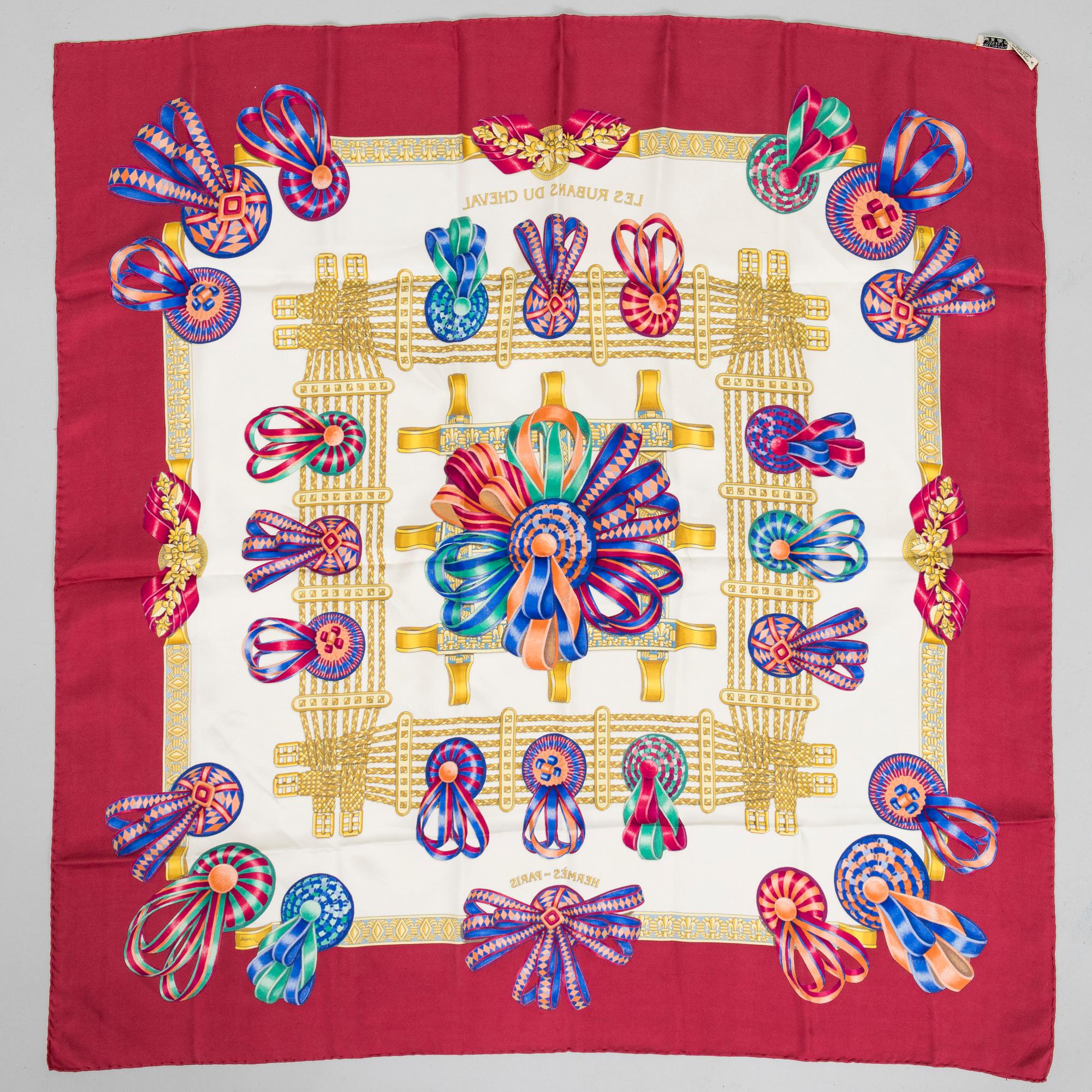 Hermès, a 'Les Rubans du Cheval' silk scarf.