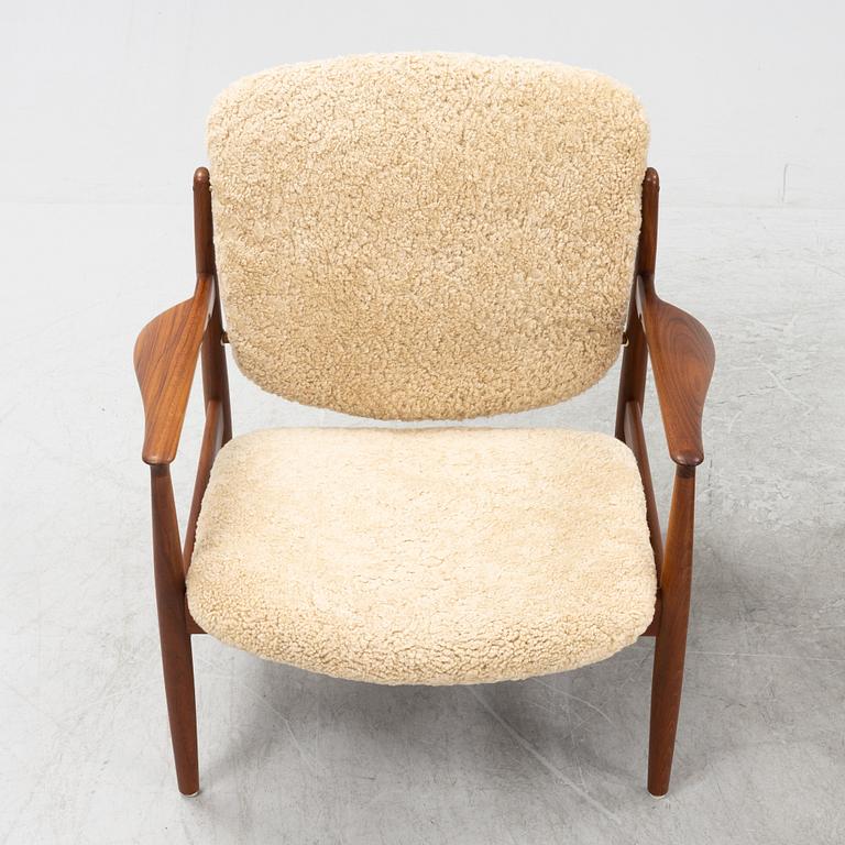 A pair of model FD 136 easy chairs with new sheepskin upholstery by Finn Juhl for France & Son, designed 1958.