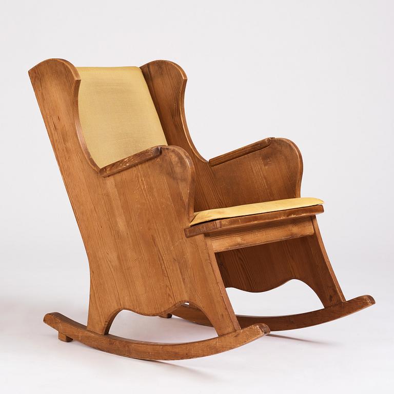 Nordiska Kompaniet, a Swedish Modern stained pine 'Lovö' rocking chair.