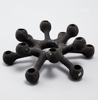 Four 1960s iron cast candle holders, designed by Jens Quistgaard for Dansk Designs .