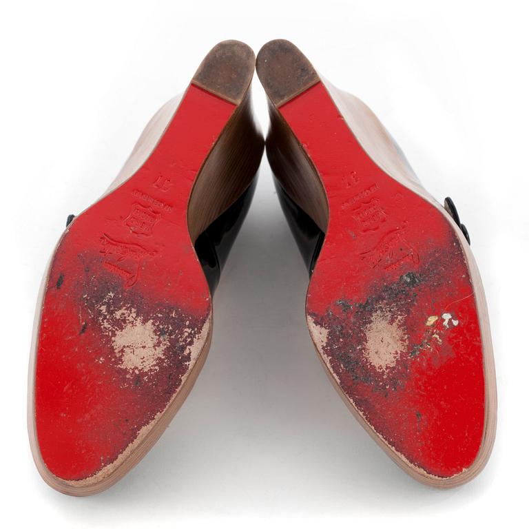 CHRISTIAN LOUBOUTIN, a pair of black patent wegde shoes, "Mary Jane Wallis". Size 37.