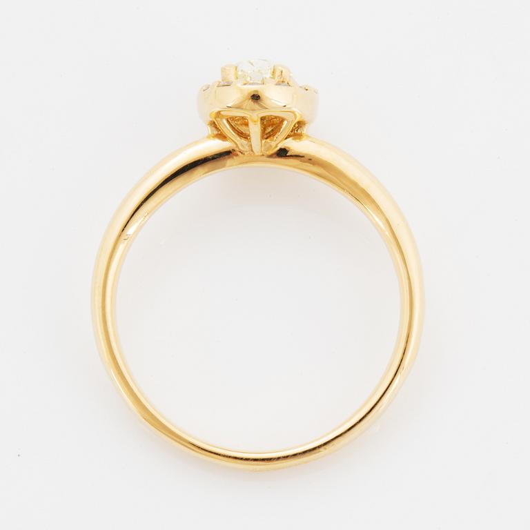 Oval light yellow diamond and brilliant-cut diamond ring.