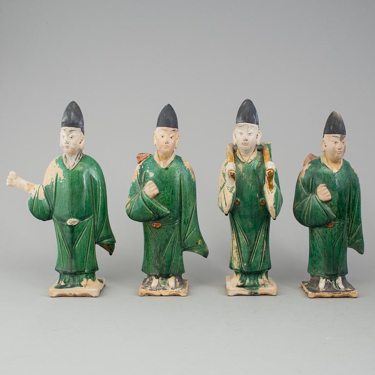 A group of eight chinese figures with three objects, earthenware, Ming dynasty.