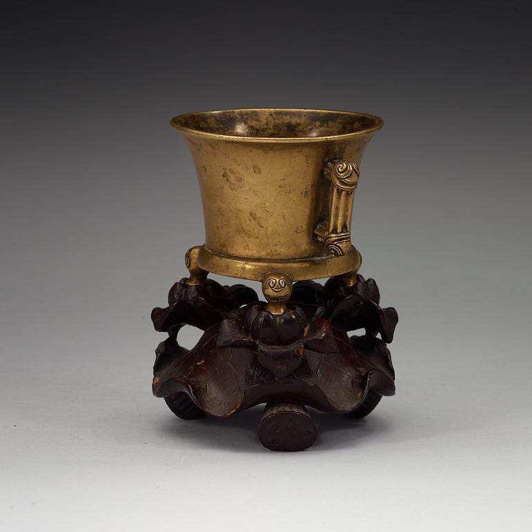 A gilt copper alloy tripod censer, Qing dynasty, presumably 18th Century with Xuandes six character mark.