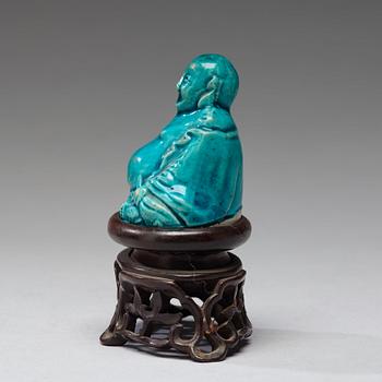 A turquoise glazed figure of Buddai, Qing dynasty, early 18th Century.