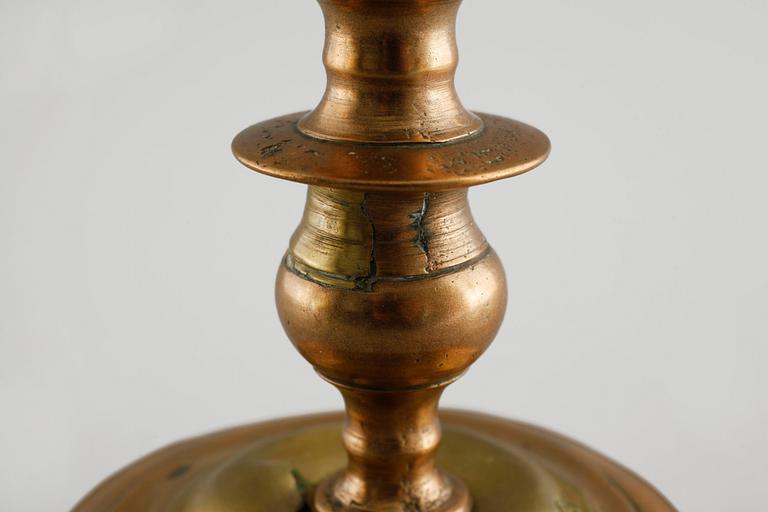 A 18th century baroque candlestick in brass.