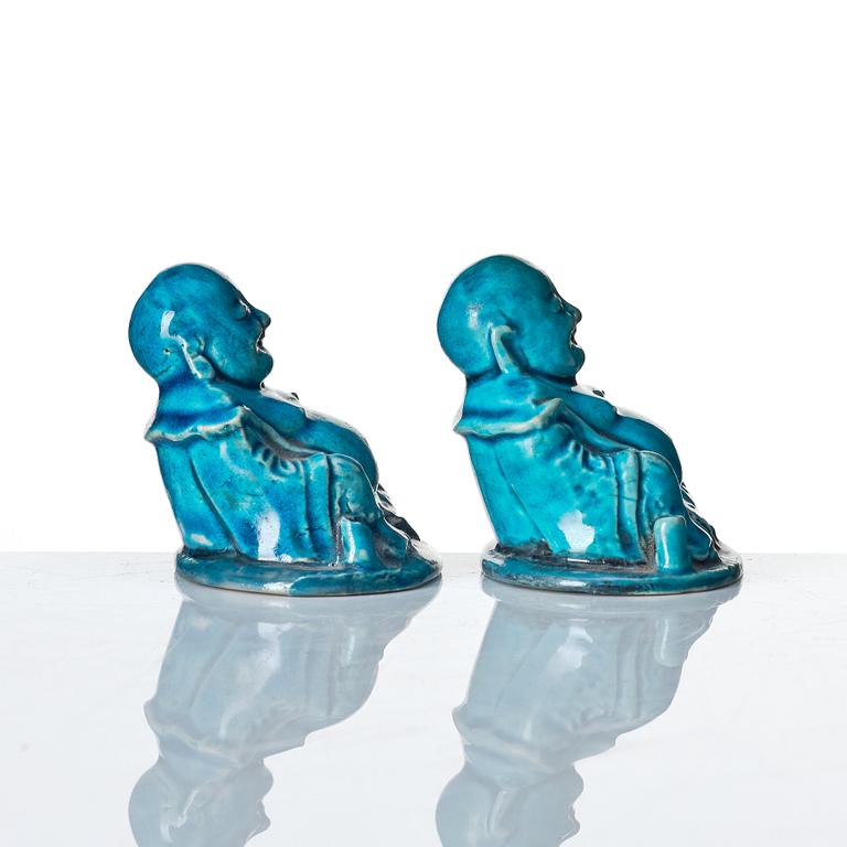 A pair of turquoise glazed joss stick holders in the shape of Buddai, Qing dynasty, 18th Century.