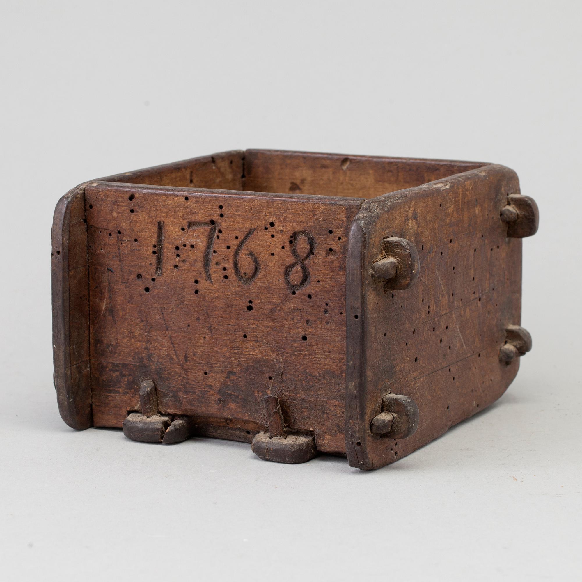 A cheese mould, dated 1768.