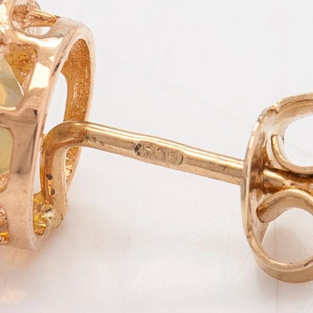 A pair of 14K gold earrings with opals.
