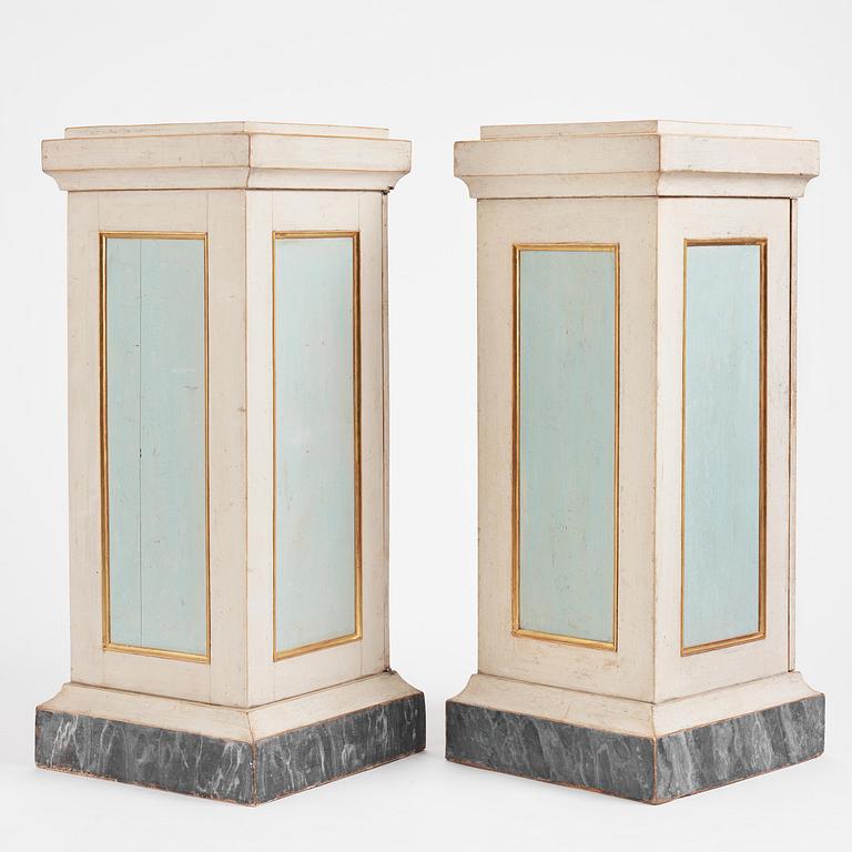 A pair of late Gustavian-style column-shaped cabinets, Stoockholm, early 19th century and later.